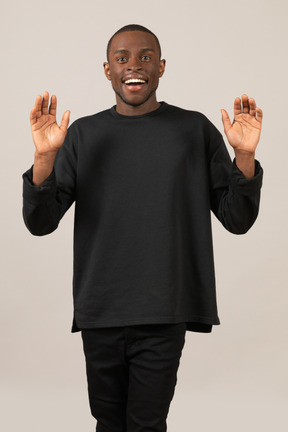 Excited young man with raised hands