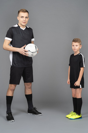 Full-length of a young man coaching little boy