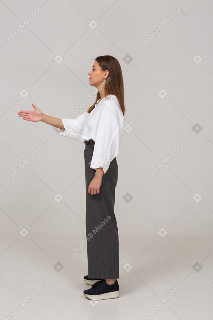 Side view of a young lady in office clothing showing the right direction