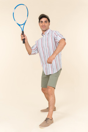 Young caucasian man holding tennis racket