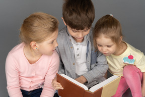 Three adorable  kids binge-reading