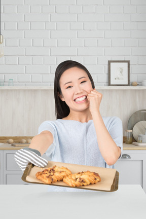 A woman sitting at a table with a tray of food