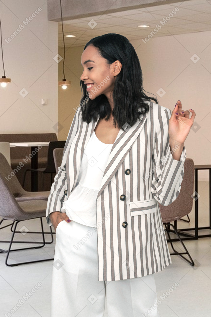 A woman in a striped jacket and white pants