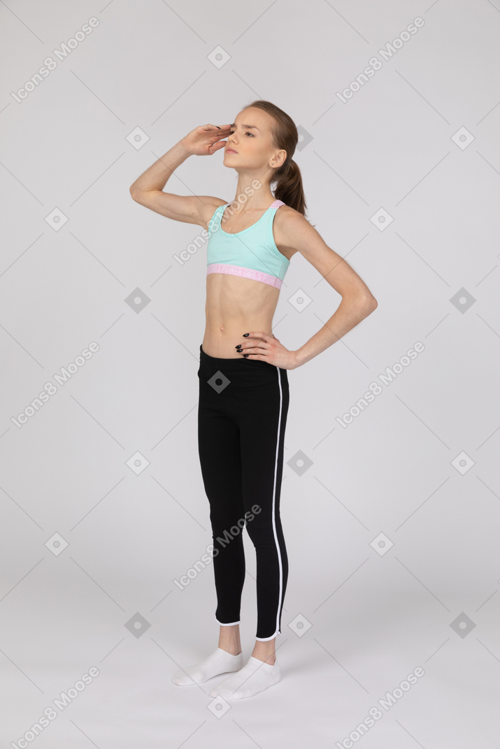 Teen girl in sportswear saluting