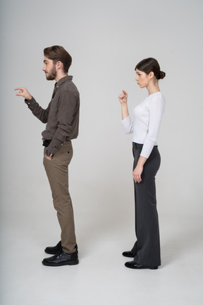 Side view of a young couple in office clothing showing size of something