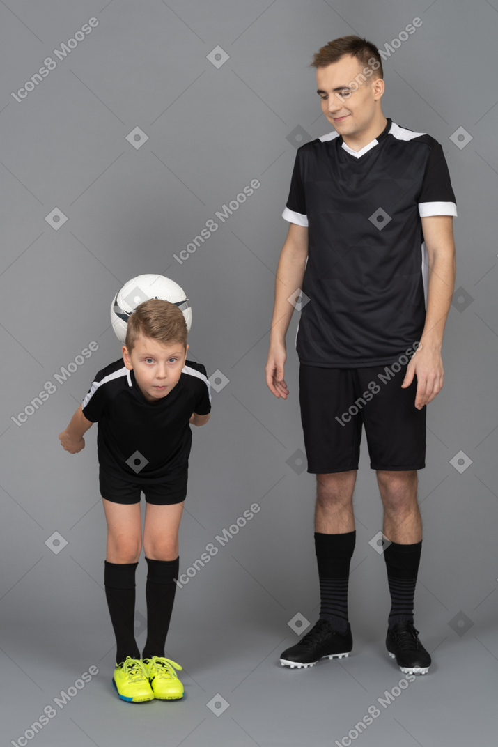 Full-length of a young man coaching little boy