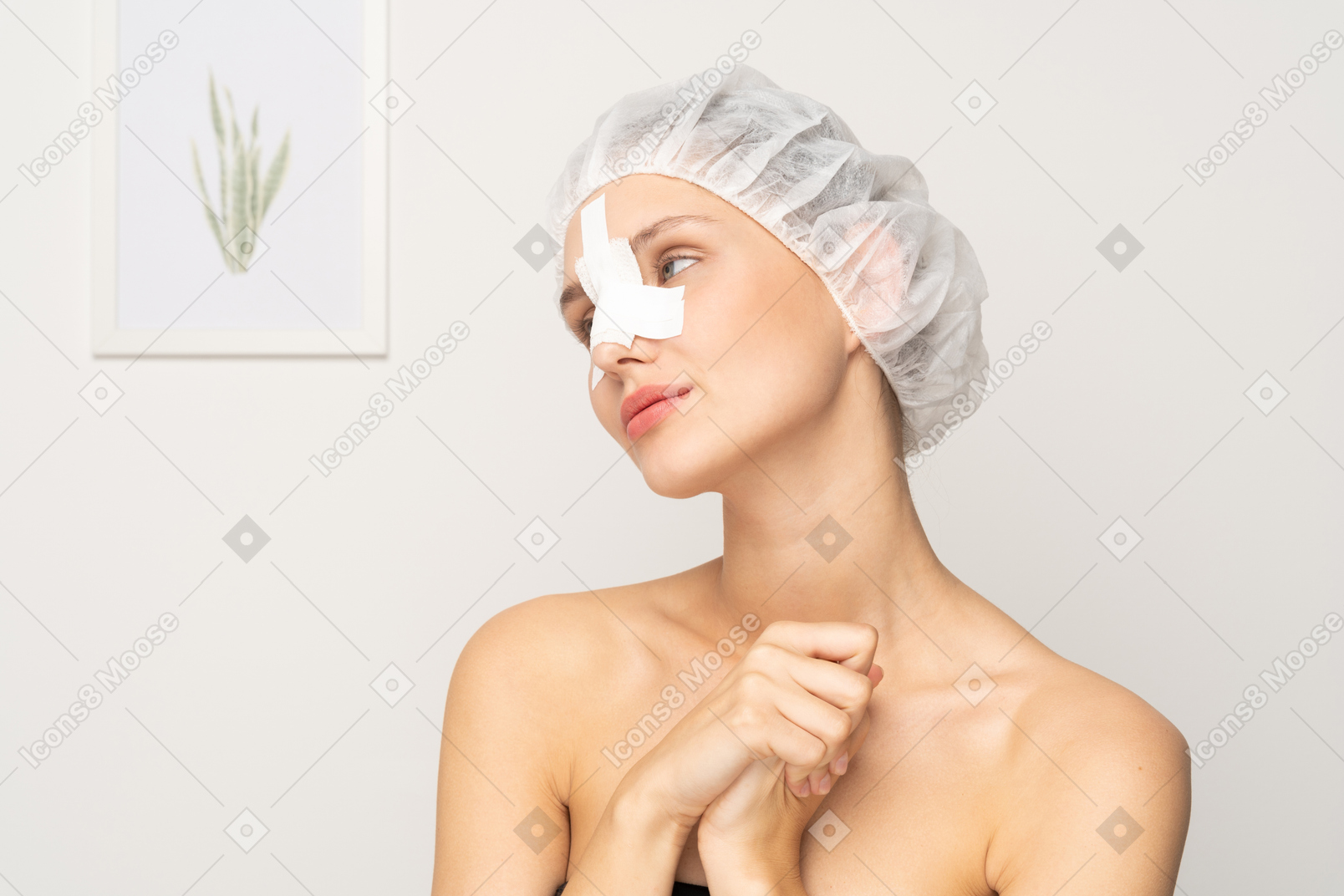Young female patient with bandaged nose looking aside