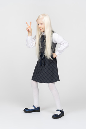 Schoolgirl making v sign