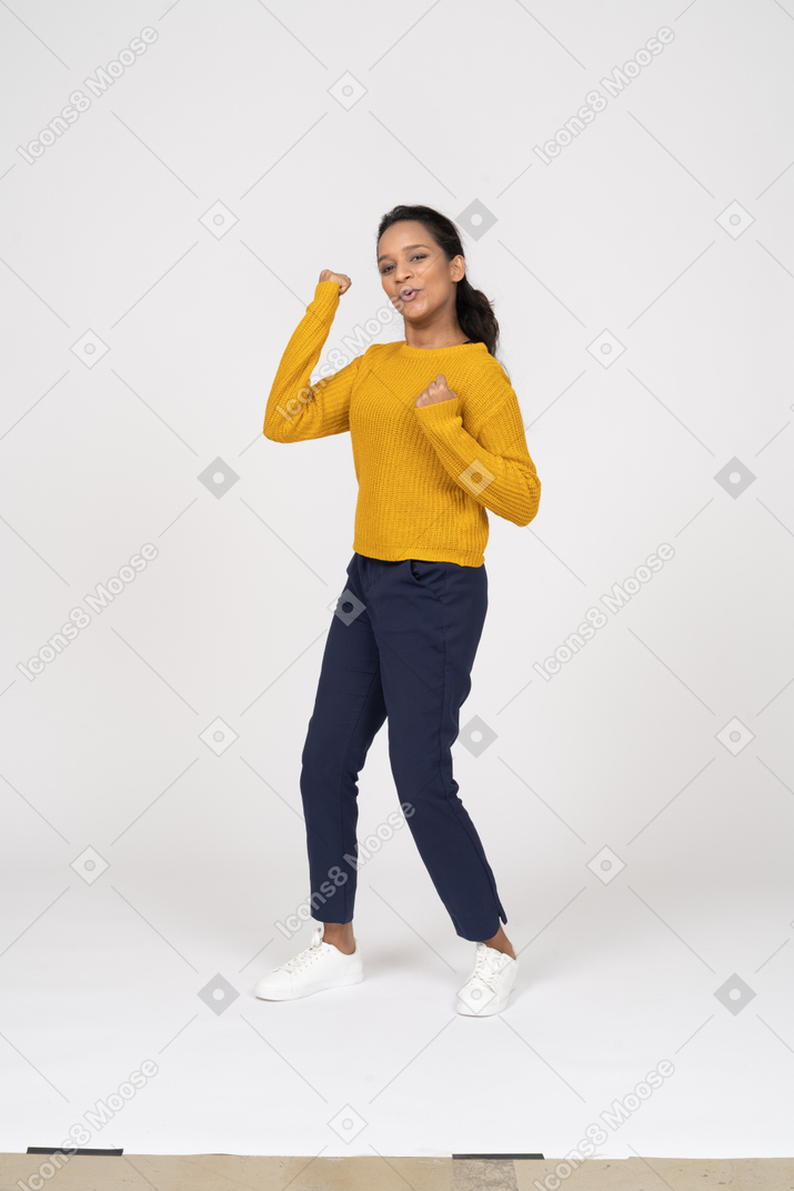 Front view of a dancing girl in casual clothes