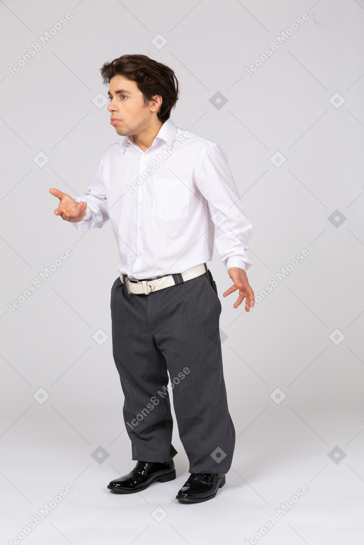 Man in formalwear asking questions with hands raised