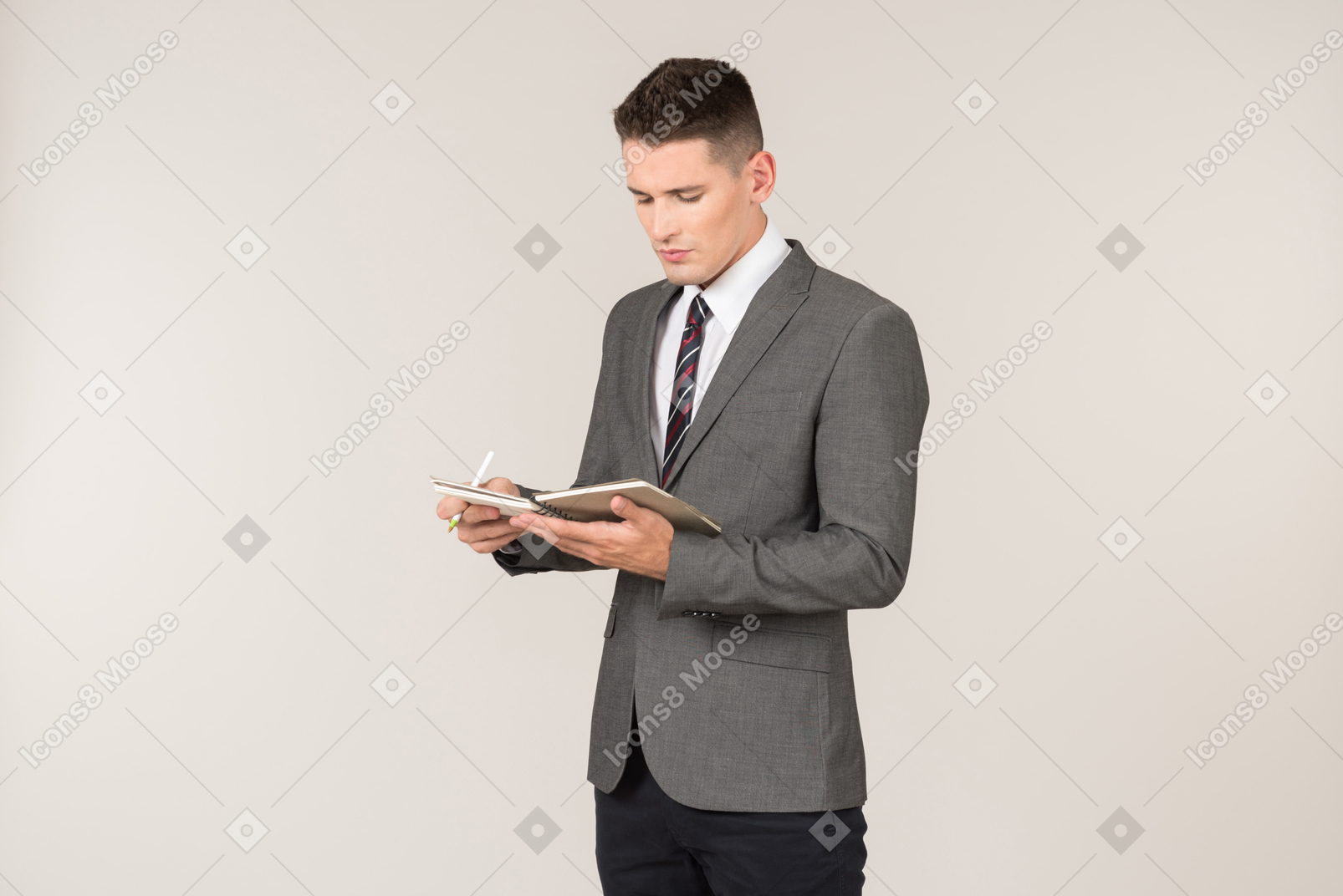 Young reporter reading something written in the notebook