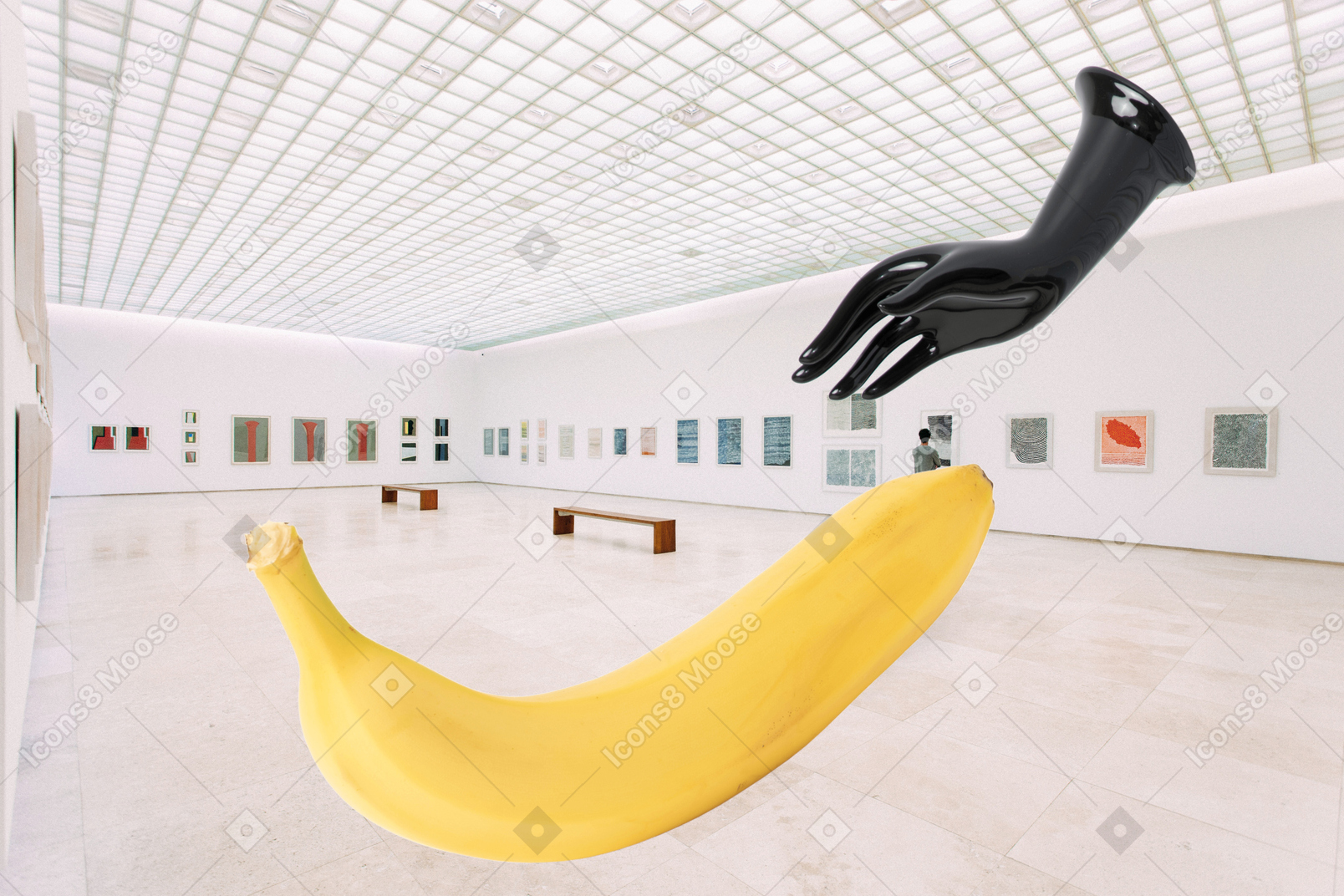 Giant black pkastic hand trying to reach giant banana in museum