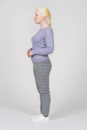 Profile view of a young woman standing with her eyes closed