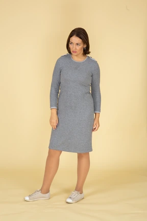 Front view of a sad woman in grey dress