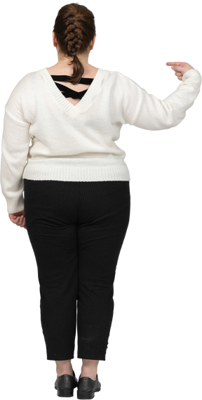 Plump woman in casual clothes pointing with a finger