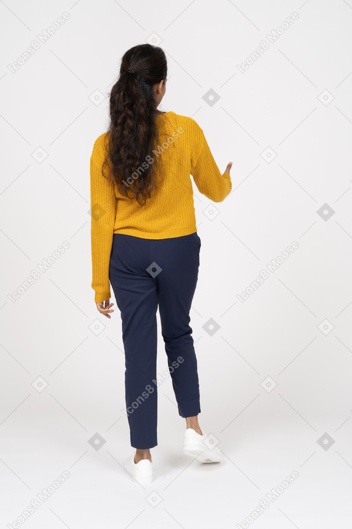 Rear view of a girl in casual clothes showing thumb up