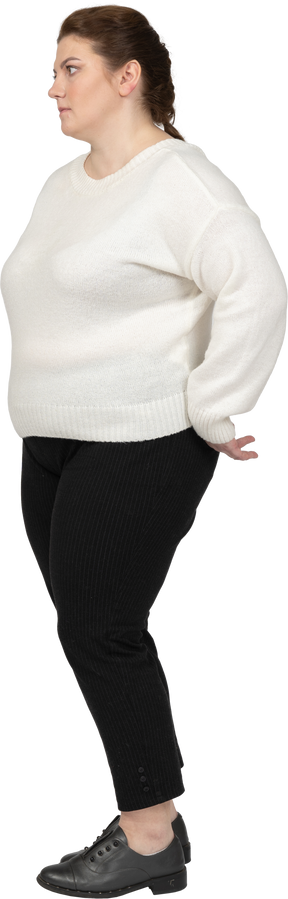 Donna grassoccia in maglione bianco in posa