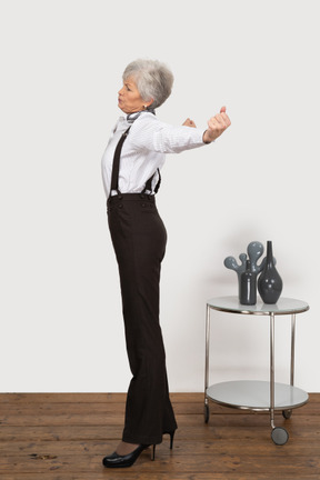 Side view of an old lady outspreading her hands