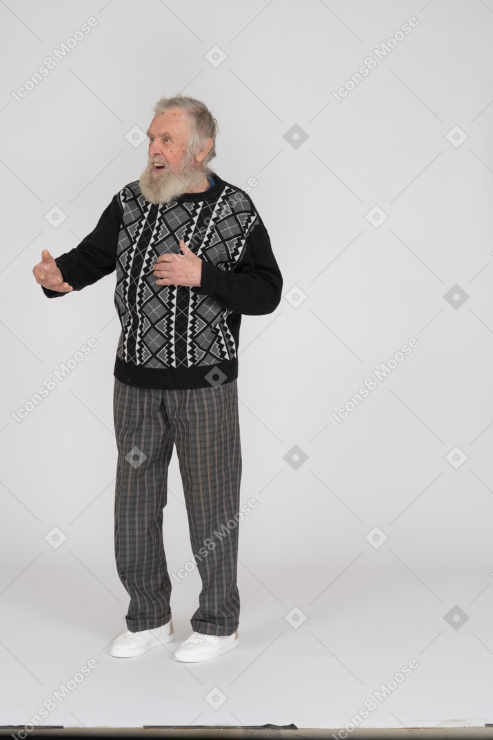Smiling elderly man outstretching his arm