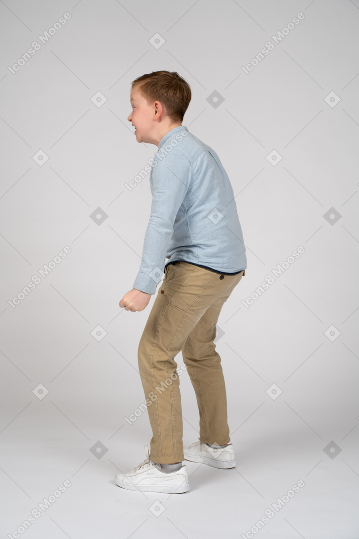 Side view of a boy showing how strong he is