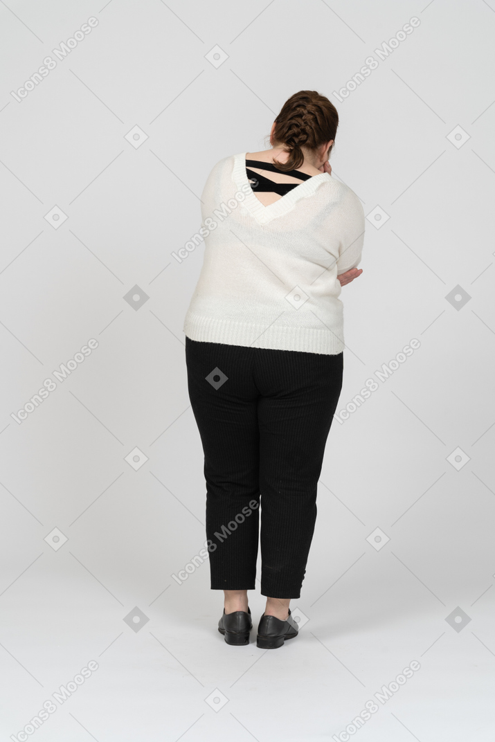 Rear view of a plus size woman in casual clothes
