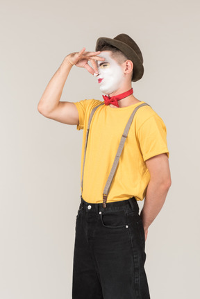 Male clown standing with disgusted face and closing nose