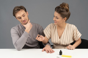A couple sitting at a table and getting ready for a manicure