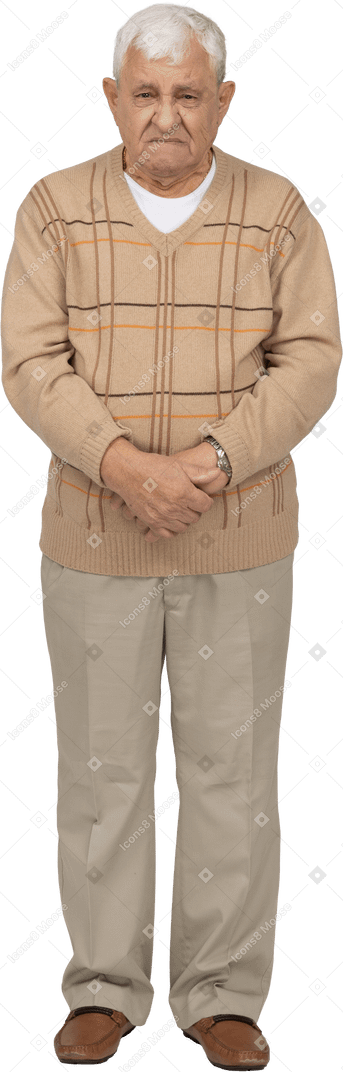 Front view of an angry old man in casual clothes looking at camera