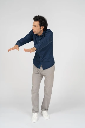 Front view of a man in casual clothes standing with outstretched arms