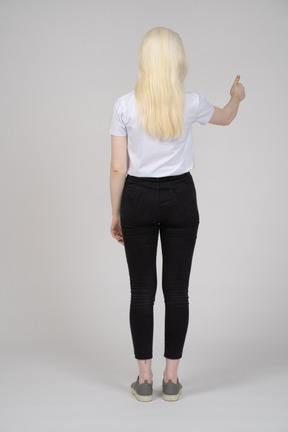 Rear view of a young girl showing a thumbs up