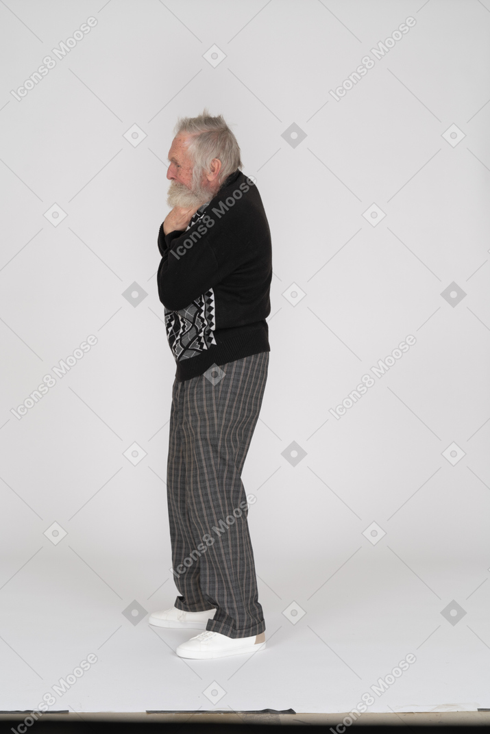 Side view of an old man holding his hands on neck
