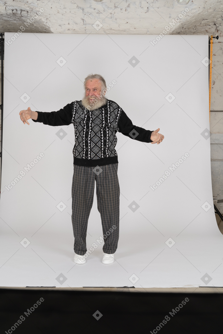 Front view of joyful elderly man standing with open arms