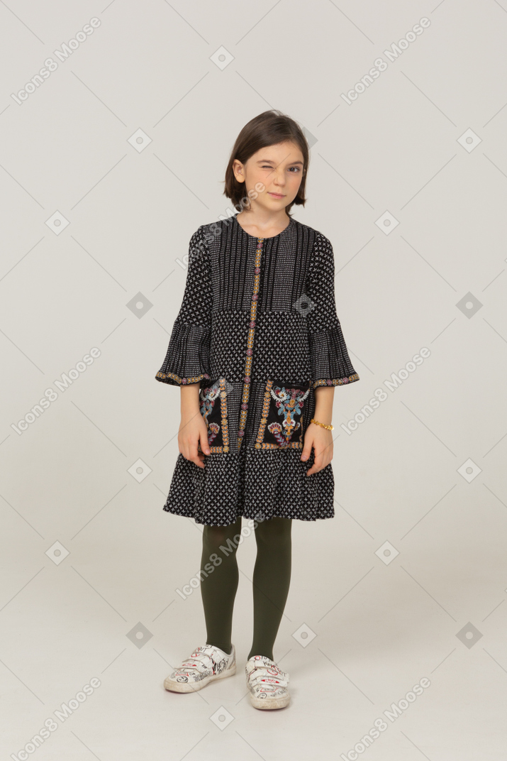 Front view of a winking little girl in dress