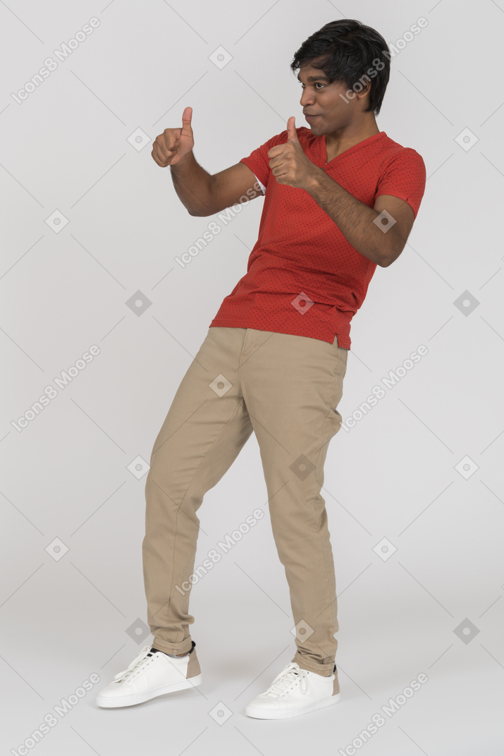 Excited young man showing thumbs up