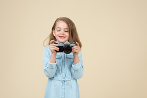 Cute little girl holding a camera