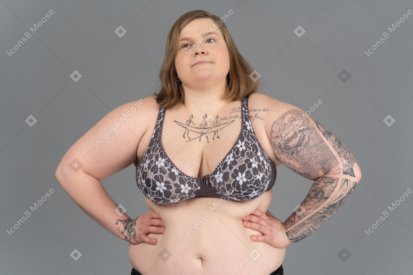 Plump woman standing with arms akimbo