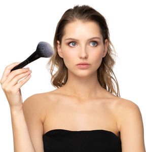 Front view of a thoughtful sensual young woman holding a make-up brush