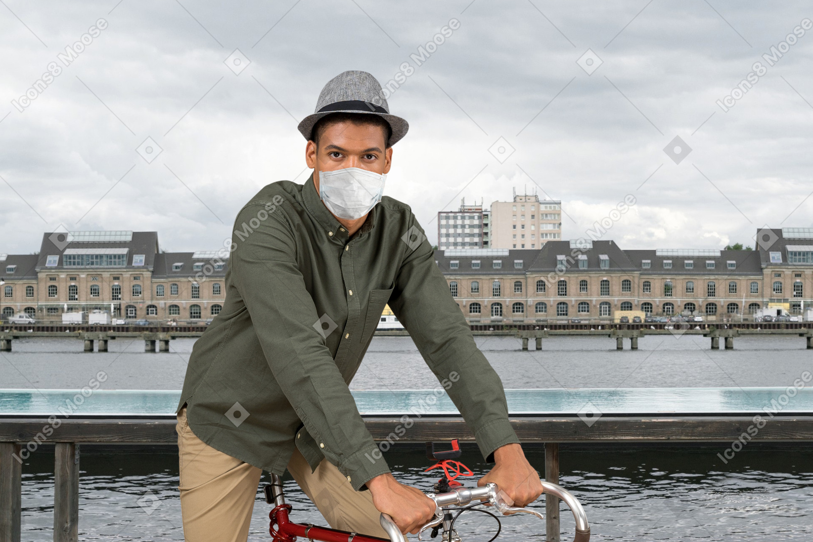 A man in a face mask riding a bike
