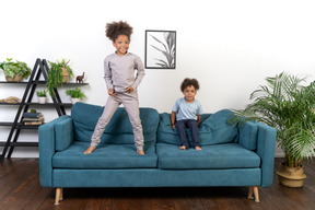 Good looking boy and girl play on the sofa