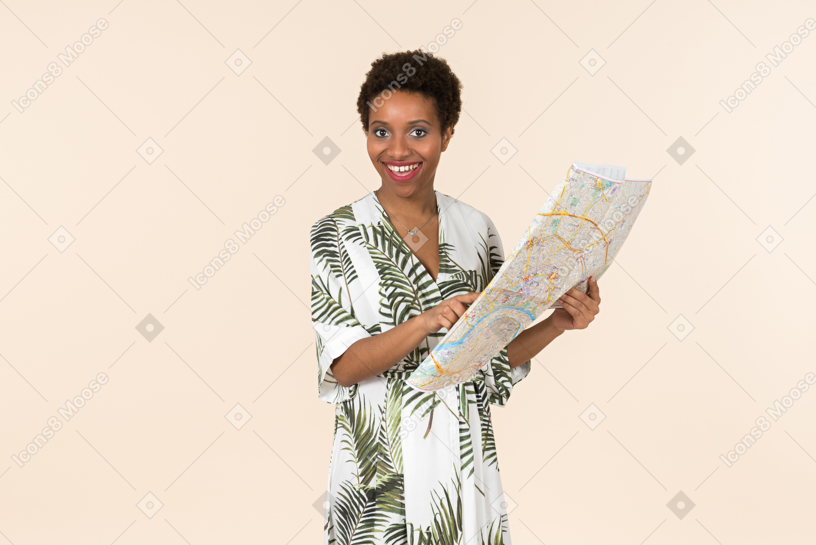 Black short-haired woman in a white and green dress, standing with a map in her hands