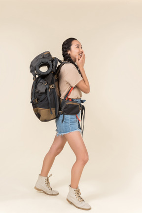 Pensive female asian hiker touching her face