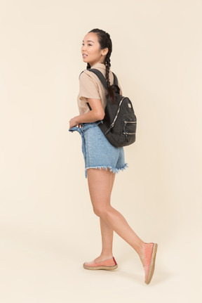 Young walking woman with backpack