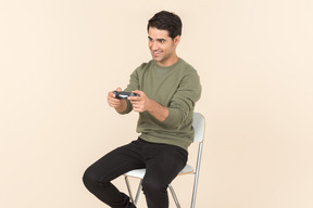 Young caucasian guy playing a videogame