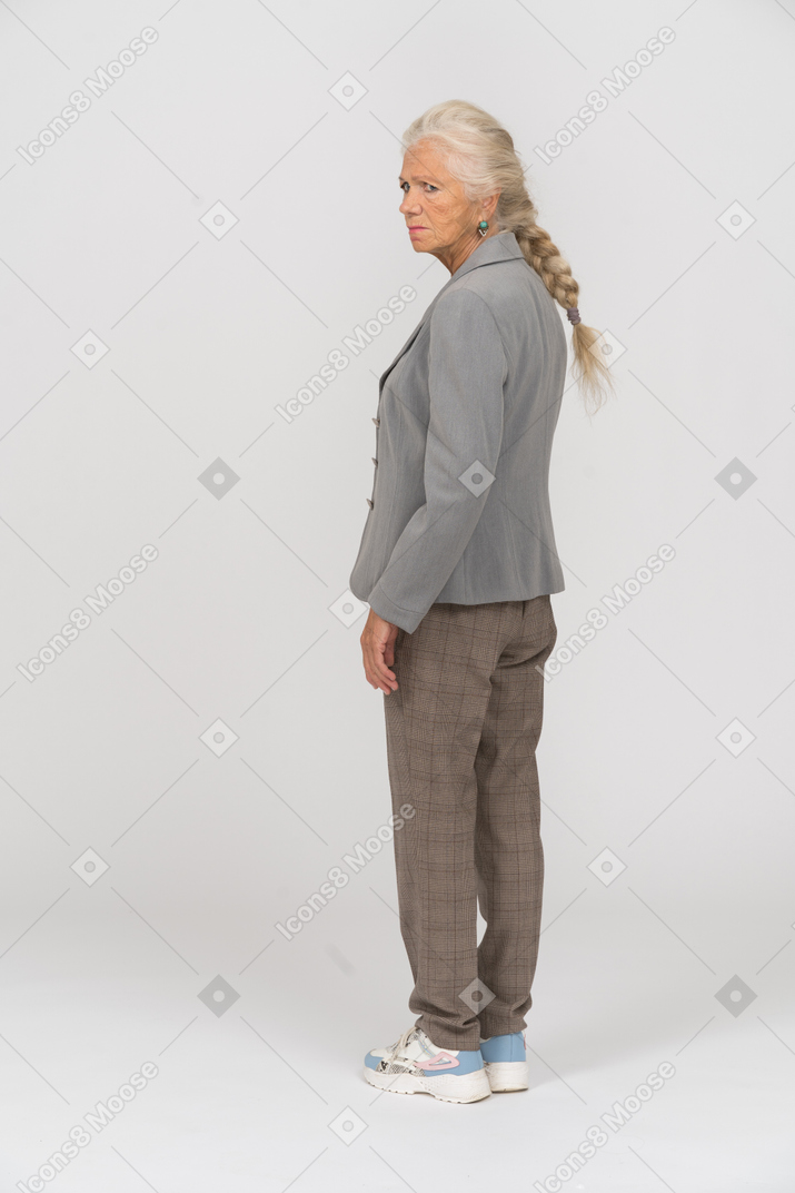 Rear view of an upset old lady in suit