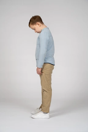 Side view of a boy bending head down