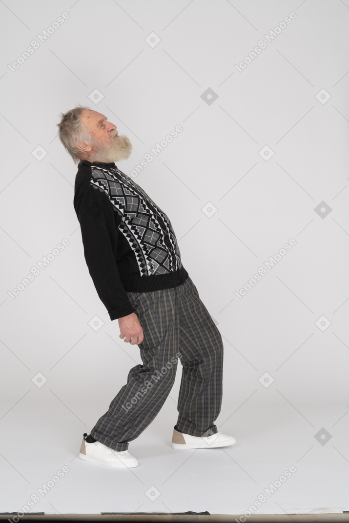 Side view of an elderly man bending back