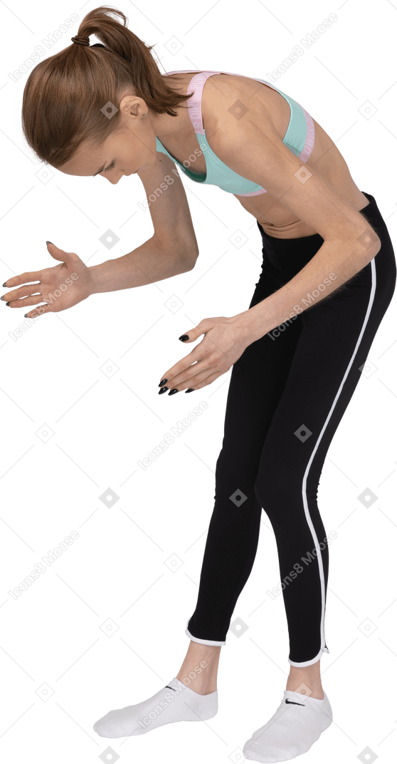 Three-quarter view of a teen girl in sportswear bending over and raising her hands
