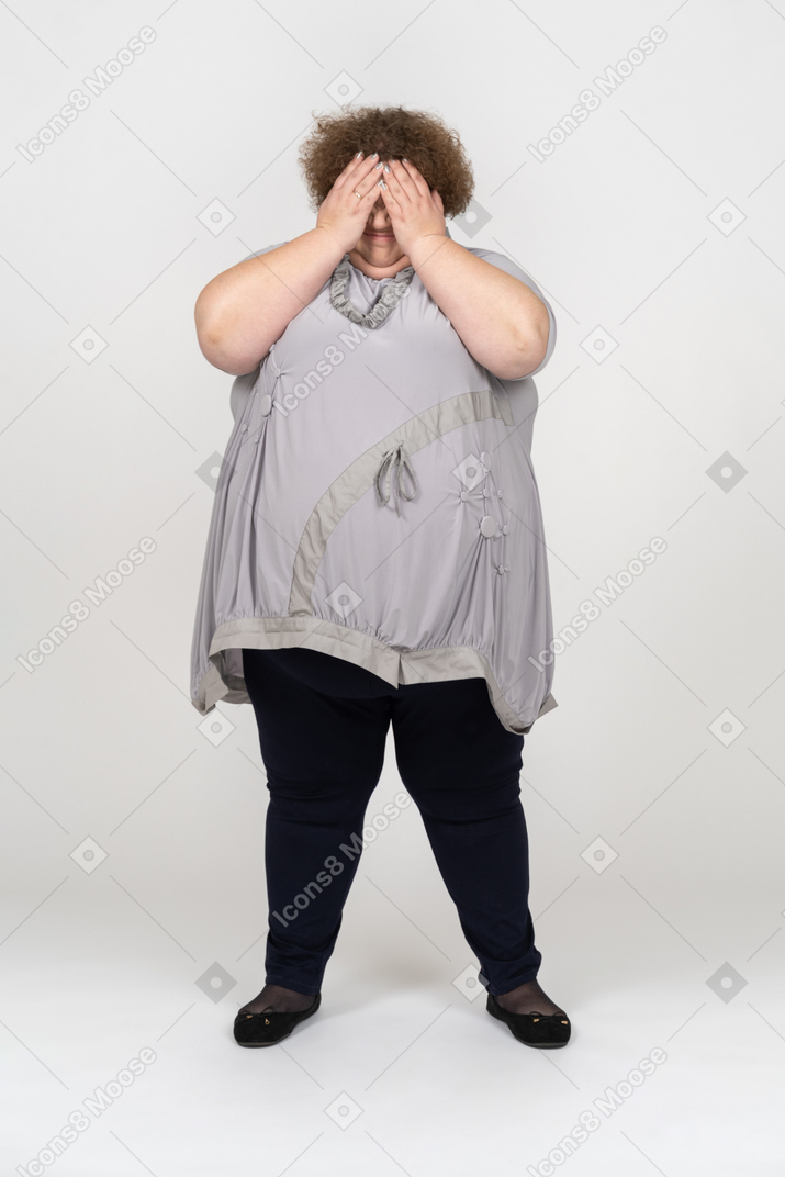 Crying woman covering her face