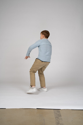 Back view of a teenager jumping backwards