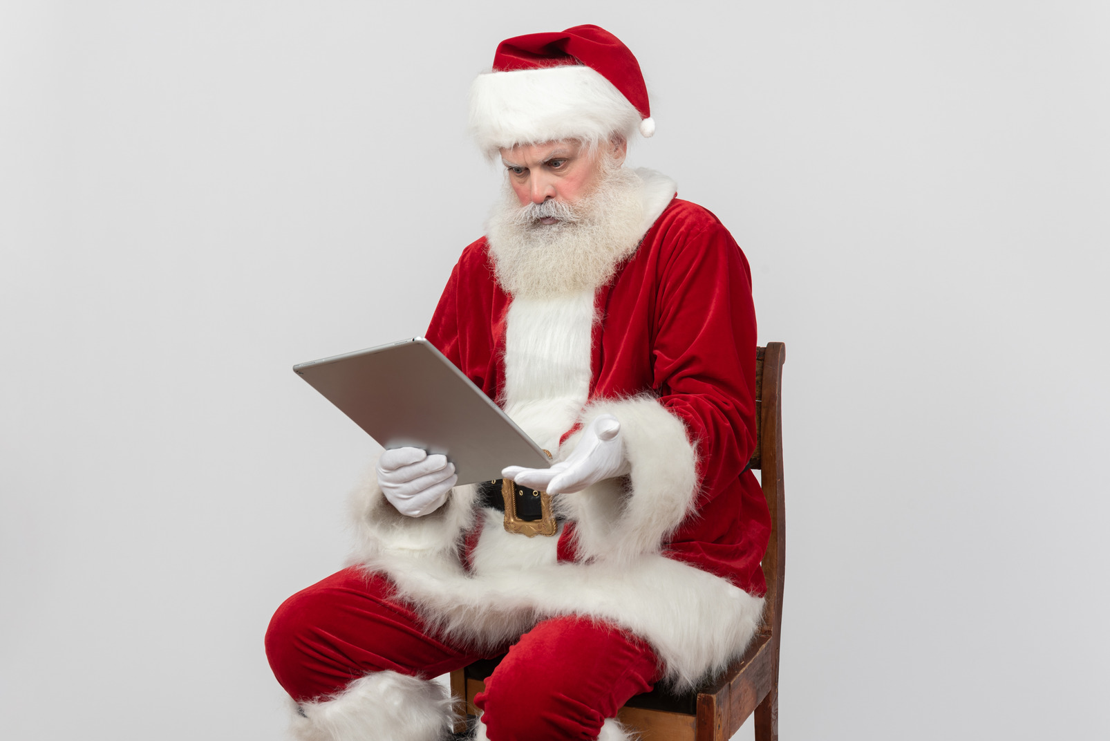 Santa claus reading folder and seems like not understanding something